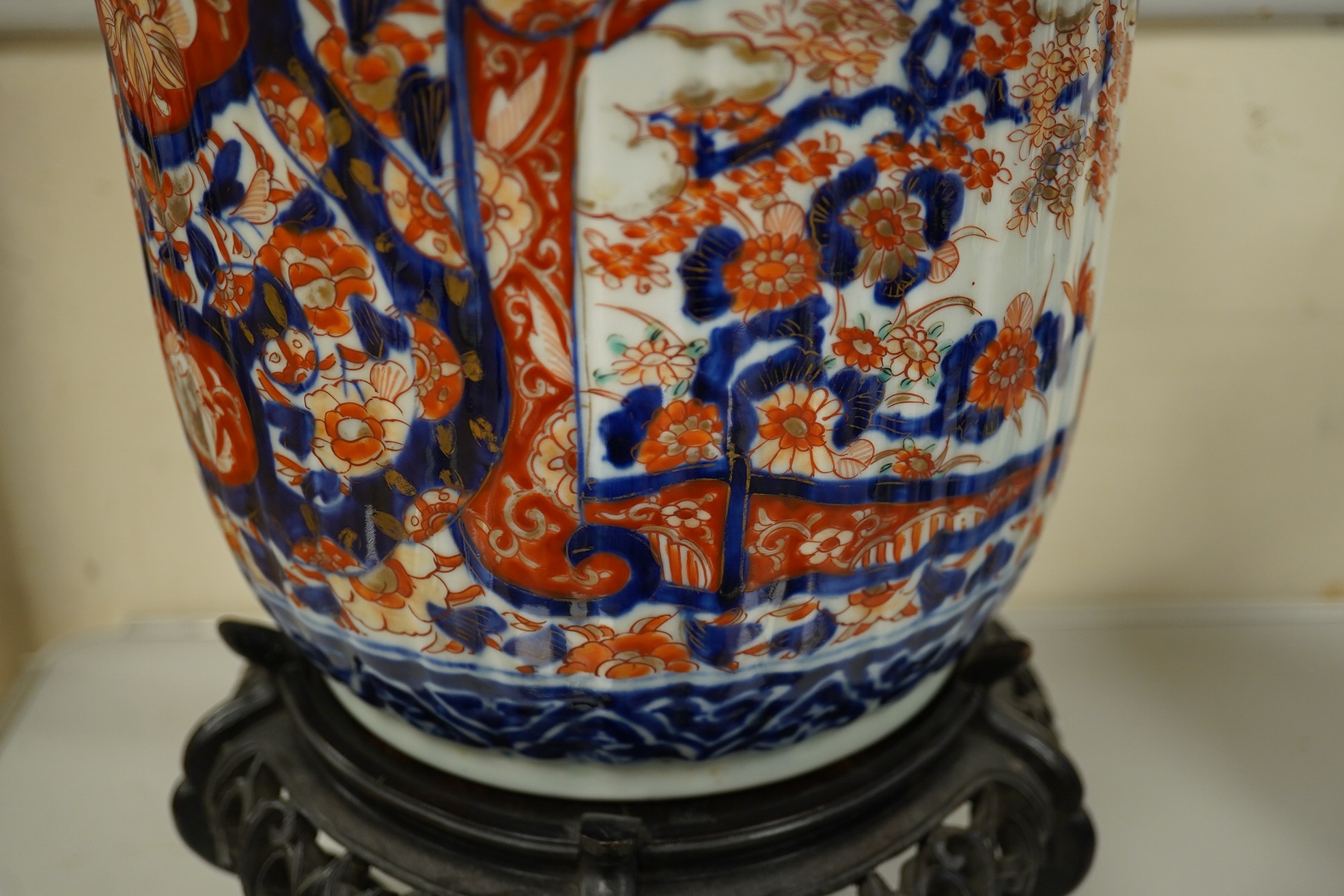 A late 19th century Japanese Imari jardiniere on Chinese hard wood stand, overall 33cm high. Condition - good, stand with some losses